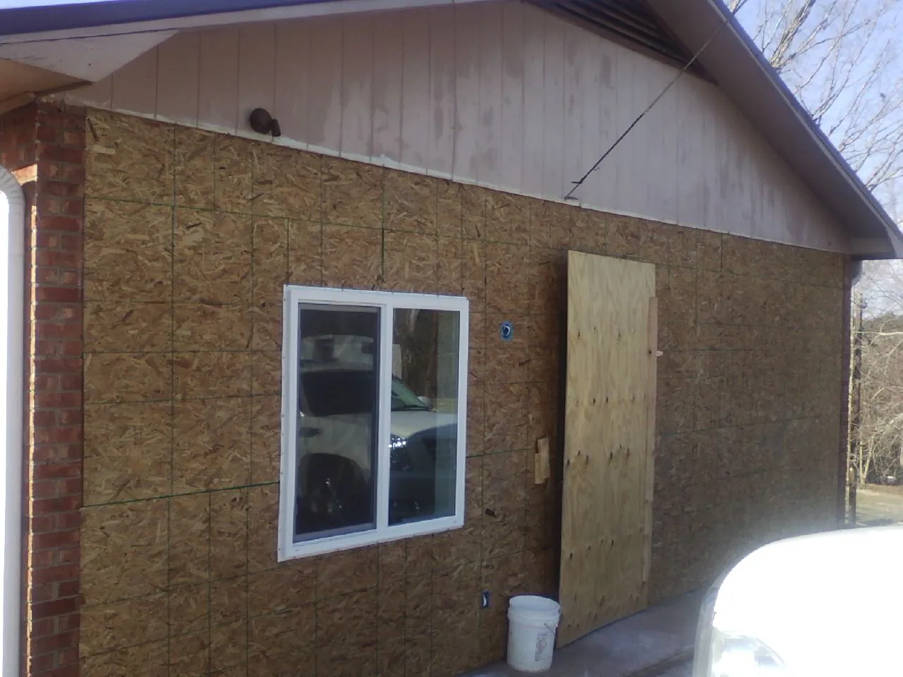 OSB sheathing on a garage addition wall before siding in Grand River
